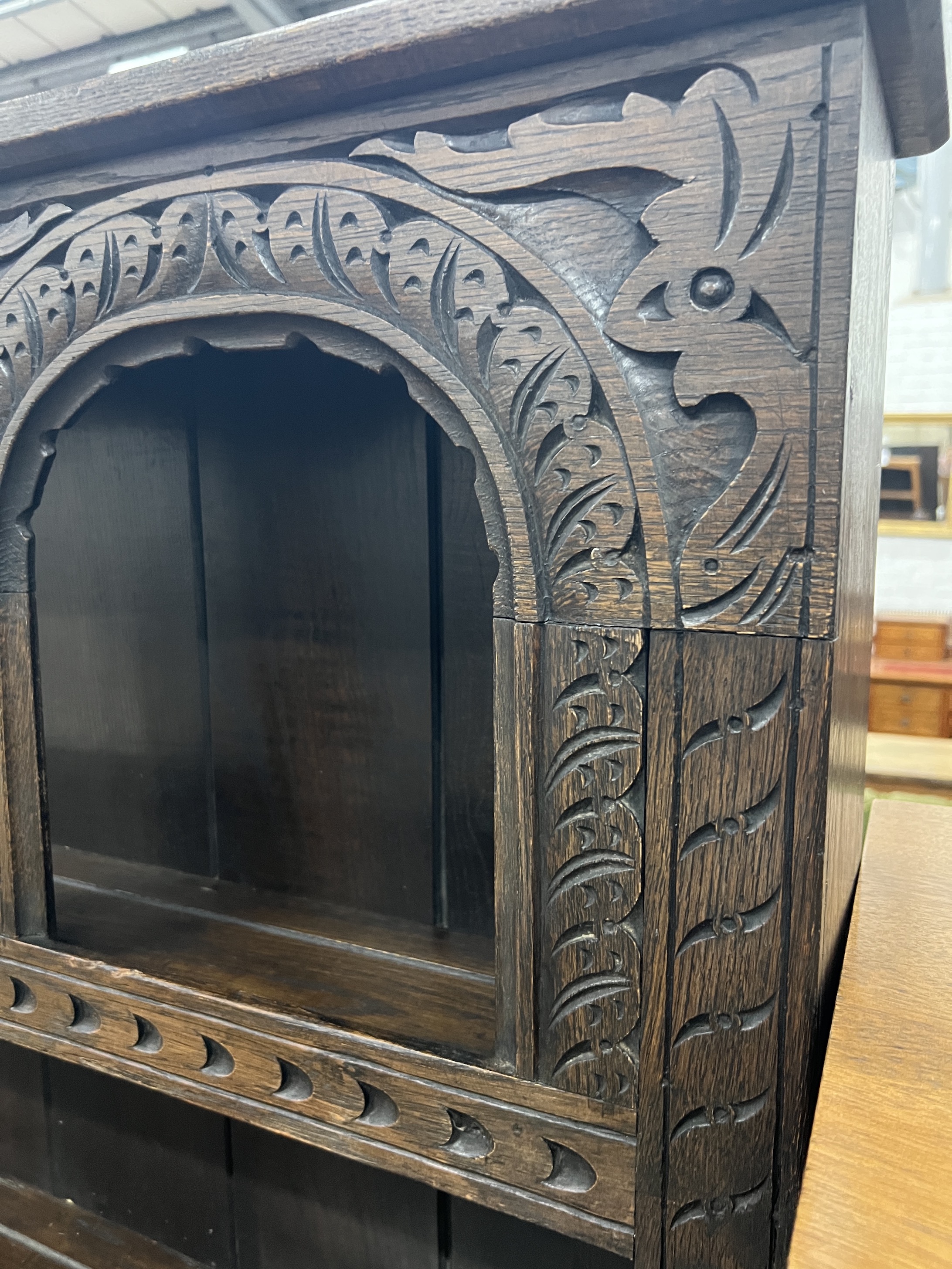 A 17th century style “Tudor Furniture” carved oak dresser, width 146cm, depth 53cm, height 168cm